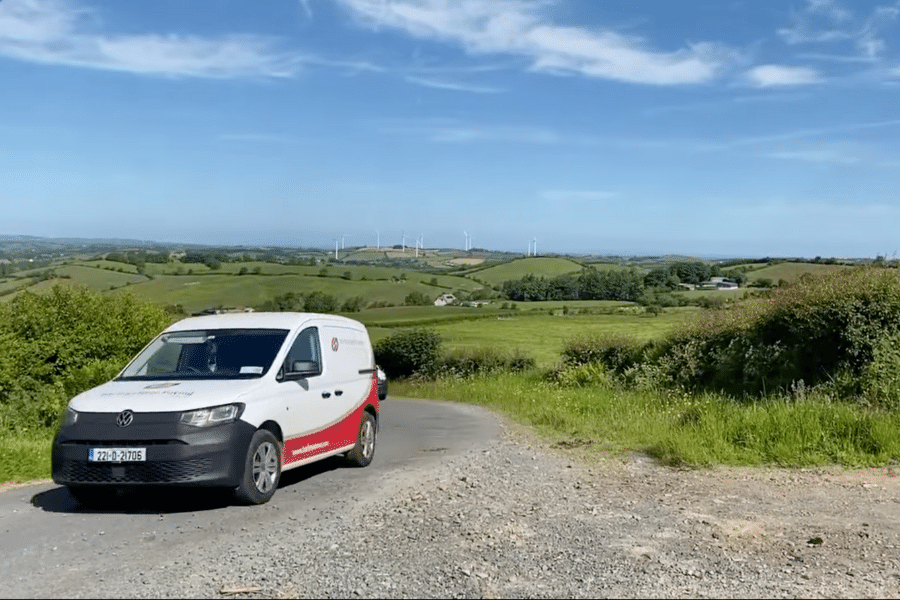 O'Reilly Group Van Fleet with Windfarms in Background
